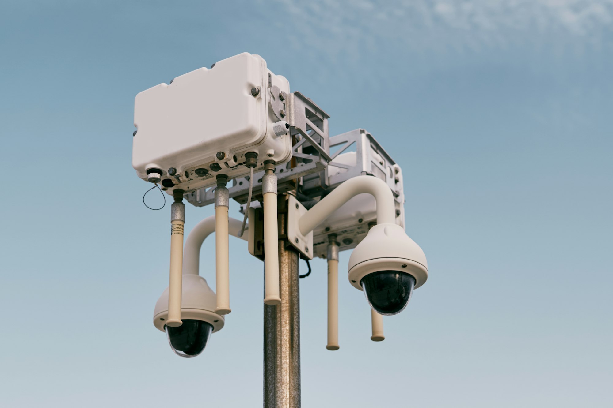 Street wi-fi router on a pole with video cameras against the sky